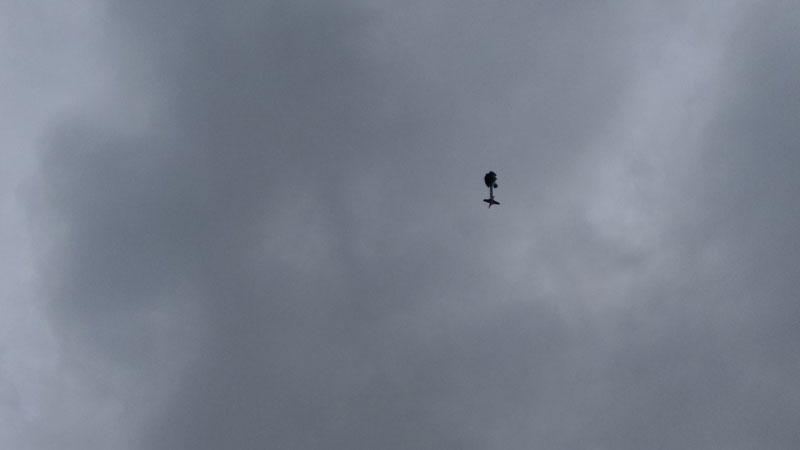 rocket with parachute against cloudy sky