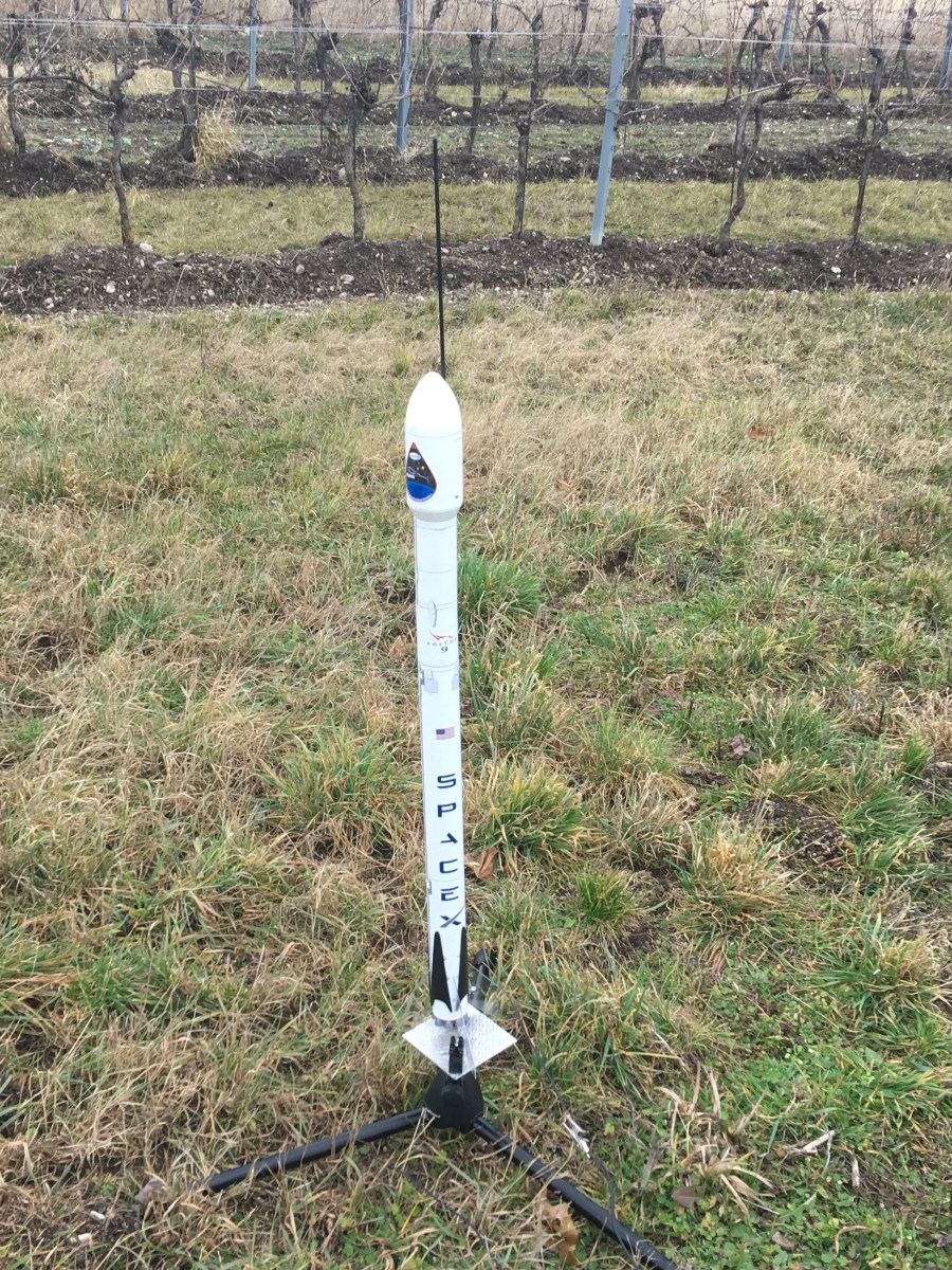 model Falcon 9 rocket in a field